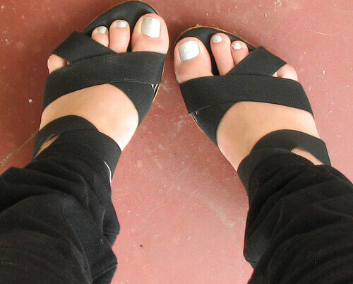 Voeten in zwarte sandalen