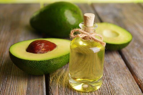 Avocado-olie in flesje met avocado ernaast