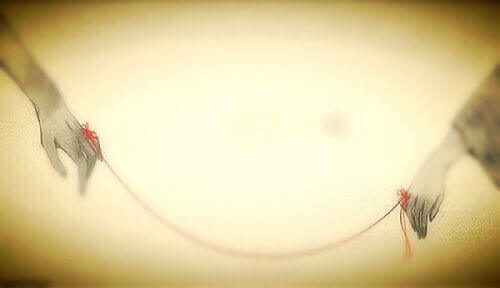 handen verbonden met een rode draad