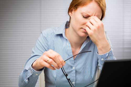 Werkende vrouw die last heeft van hoofdpijn