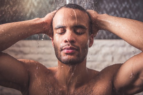 Man die onder de warme douche staat