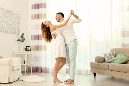 Man en vrouw dansen in de woonkamer