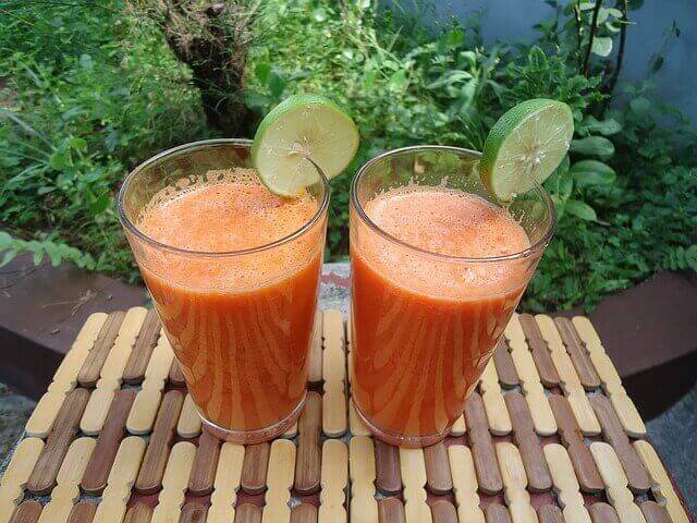 twee glazen met een oranje smoothie