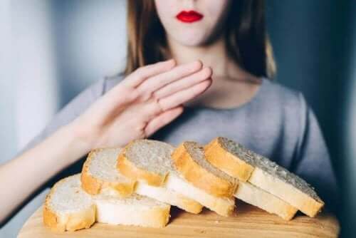 vrouw zegt met hand nee tegen wit brood