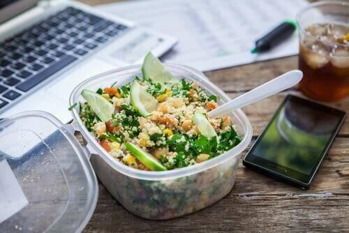 Een salade in een bakje op een bureau