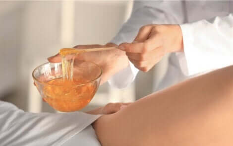 Vrouw die een kom hete wax vasthoudt