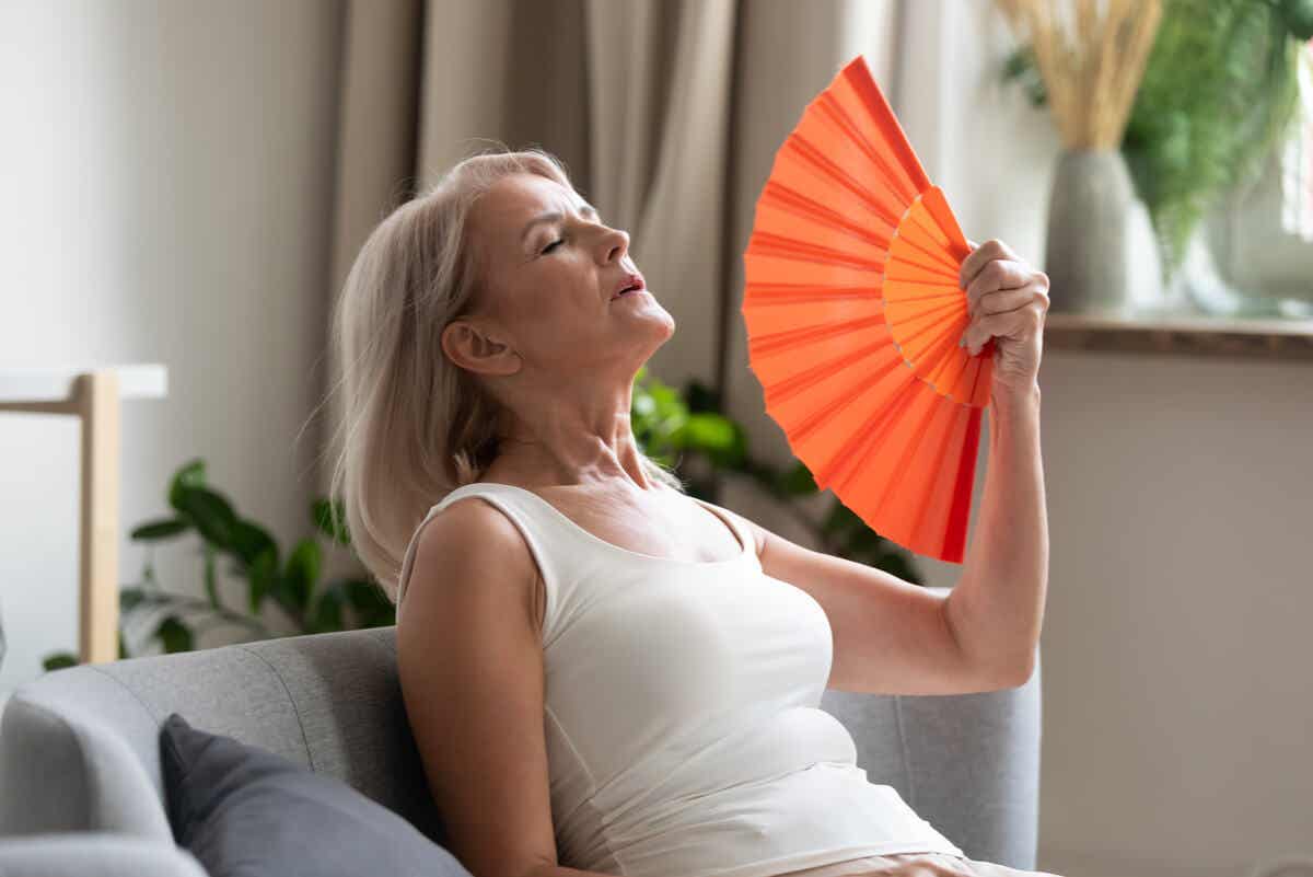 Vrouw wuift zichzelf koelte toe